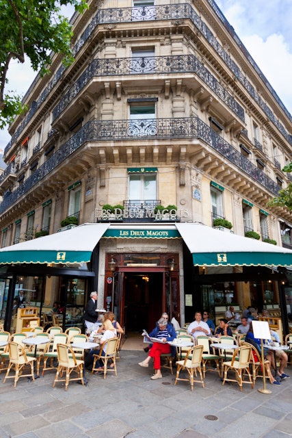 Paris, France - June 27, 2012: Cafe Les Deux Magots. Les Deux Magots is a famous caf!AA> in the Saint-Germain-des-Pr!AA>s area of Paris. It once had a reputation as the rendezvous of the literary and intellectual !AA>lite of the city. It is now a popular tourist destination. Parisians and tourists are enjoying a beautiful summer day outside.
458231415
Capital Cities, Paris Left Bank, Residential Structure, Building Exterior, Awning, Color Image, Entrance, Eating, Sidewalk, History, Green, Architecture, Urban Scene, Outdoors, Vertical, People, St-Germain-des-Pres, Latin Quarter, Paris - France, France, Europe, Day, Summer, Sky, Balcony, House, Cafe, Restaurant, Street, Built Structure, Cafe des Deux Magots