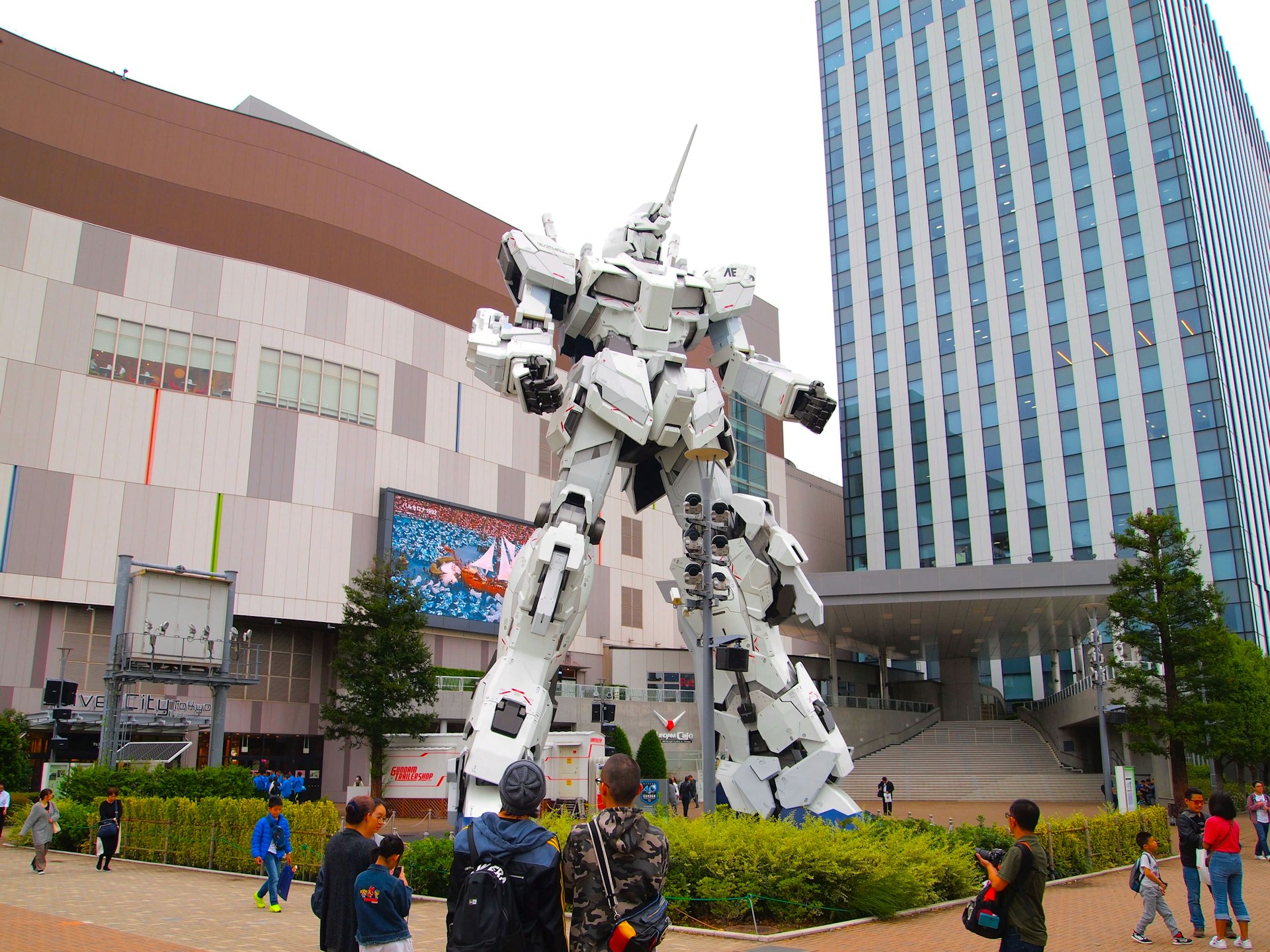 Children and families looking at the life sized unicorn Gundam Statue, a fictional robot from a famous Japanese anime series