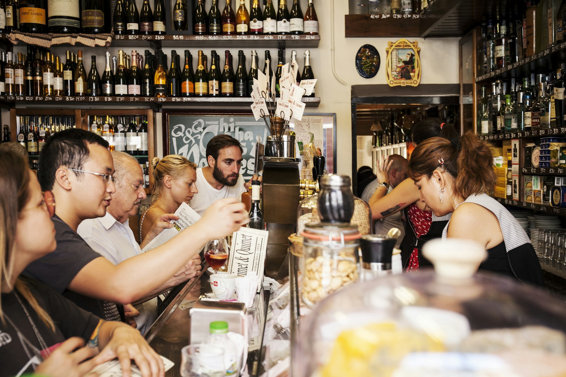 People eating and drinking at a bar in Barcelona