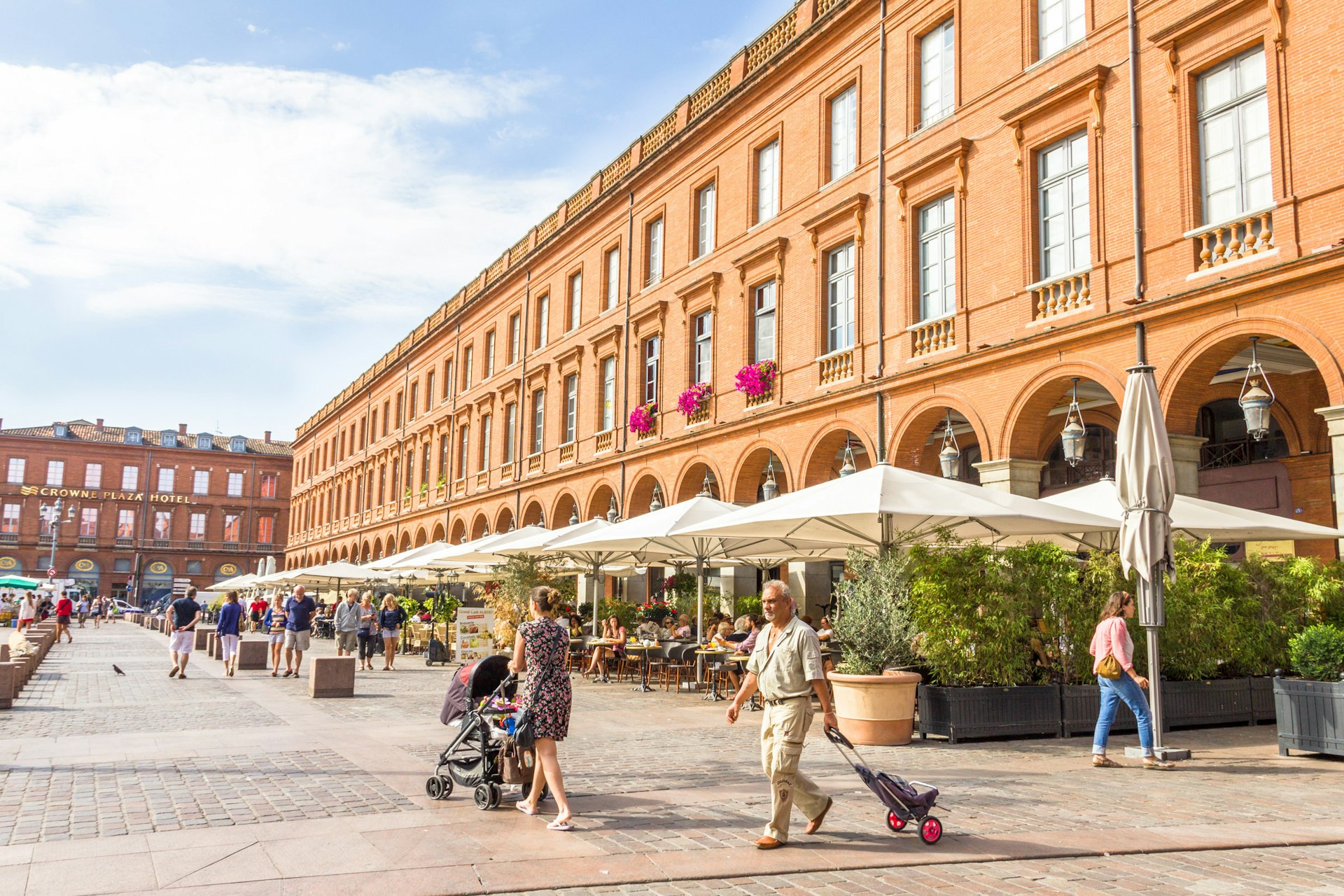 People walking in the Place du Capitole square in Toulouse, France.