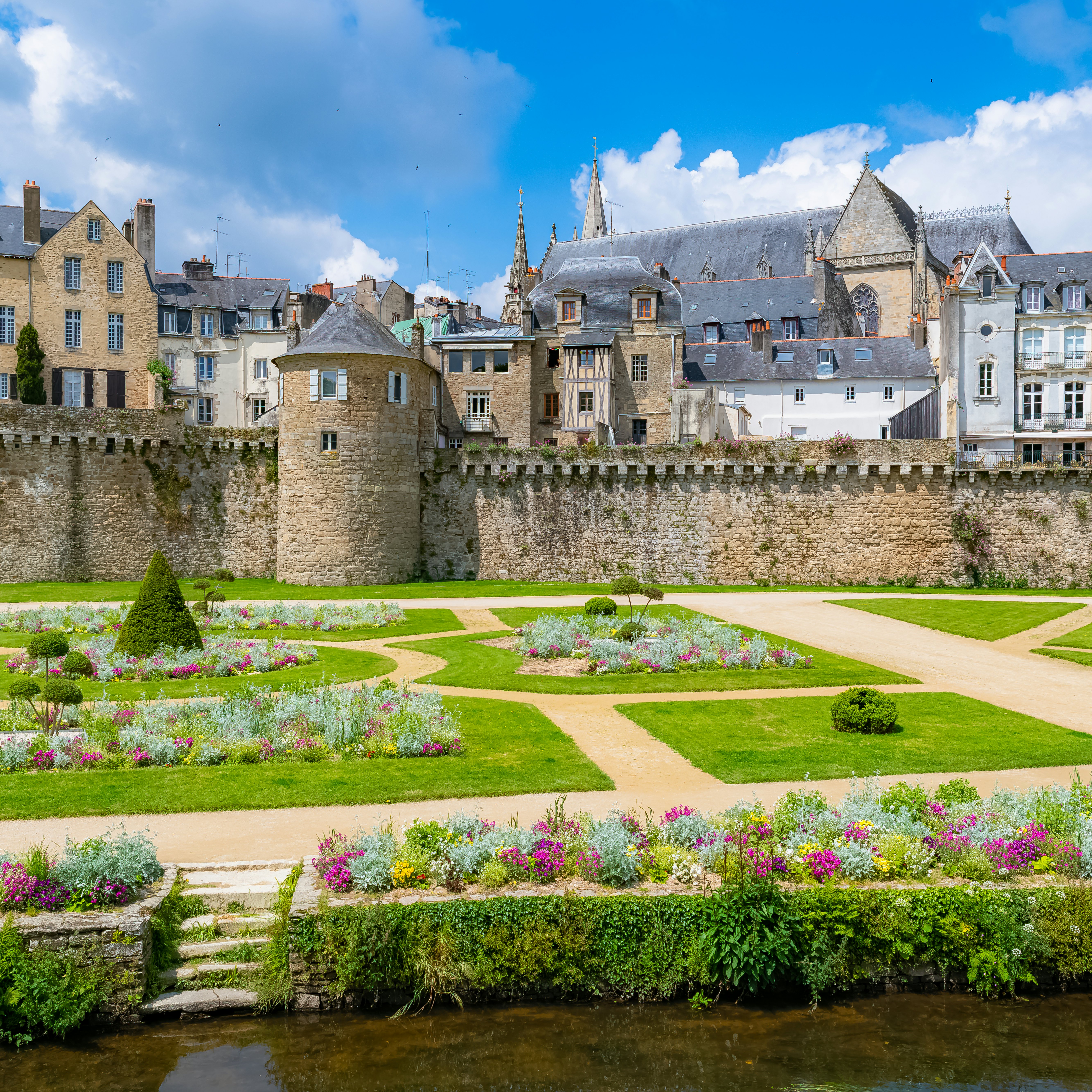 The garden of the ramparts, a public park, with the old city behind the walls in Vannes, France.