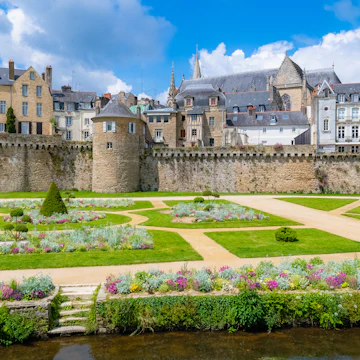 The garden of the ramparts, a public park, with the old city behind the walls in Vannes, France.