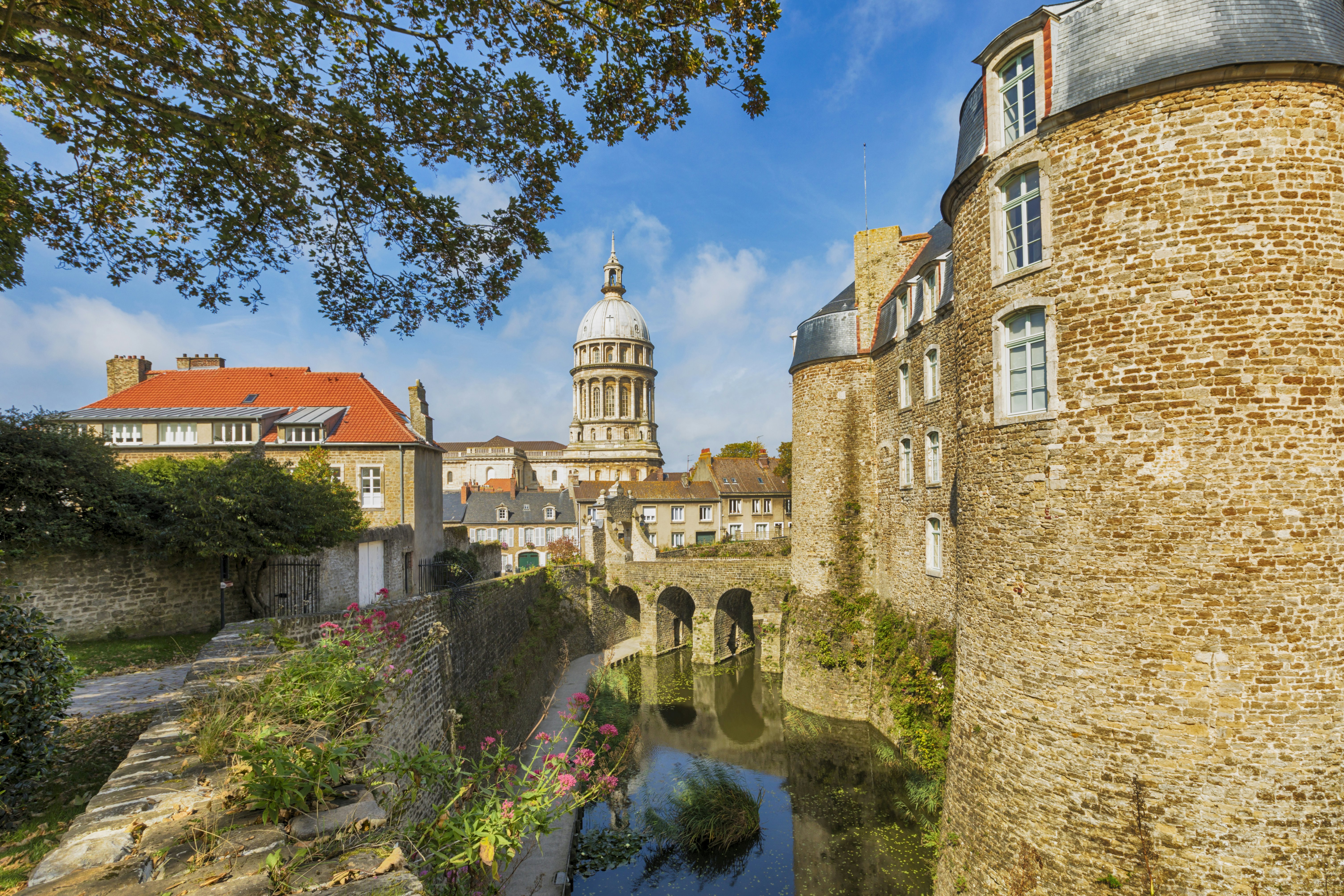 Fortified city of Boulogne-sur-Mer with castle in foreground and Basilica of Our Lady of the Immaculate Conception in background.