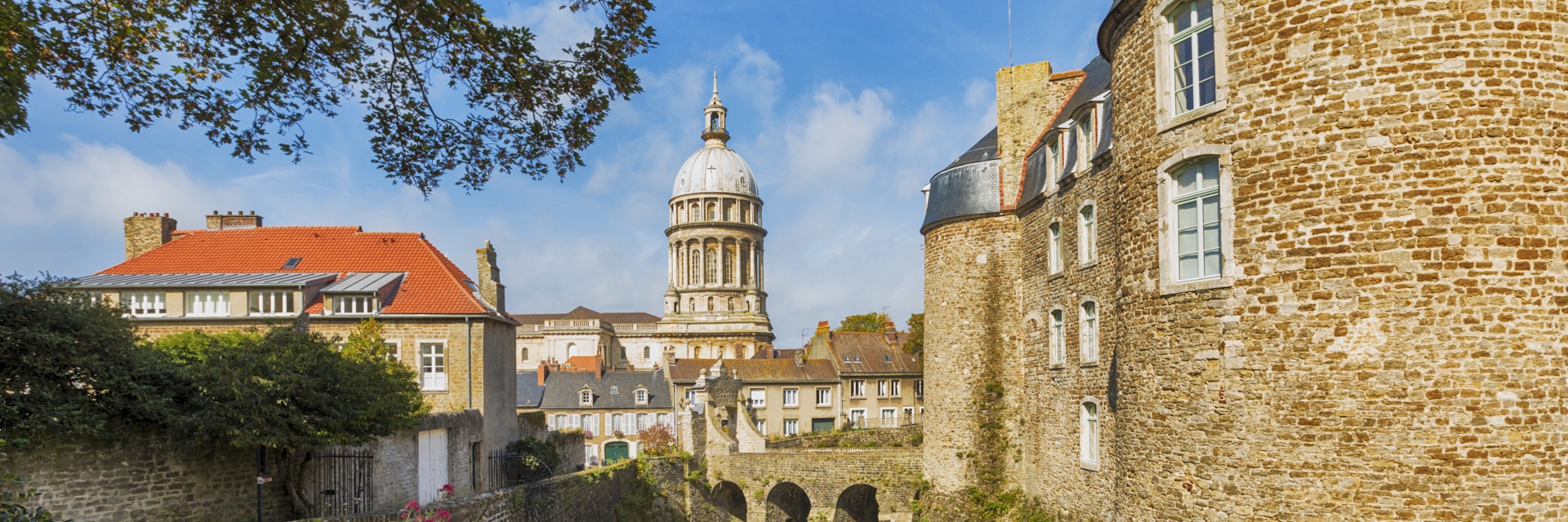 Fortified city of Boulogne-sur-Mer with castle in foreground and Basilica of Our Lady of the Immaculate Conception in background.