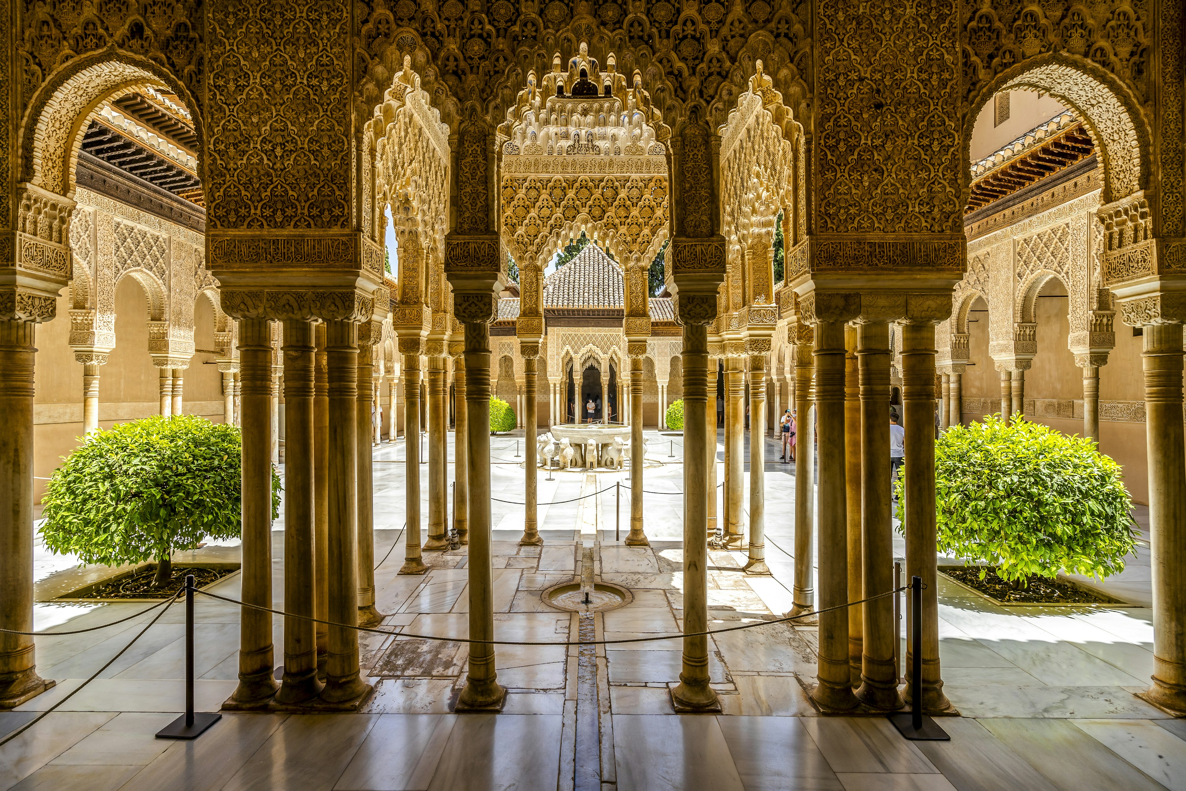 Many columns with intricate carvings at the edge of a beautiful courtyard