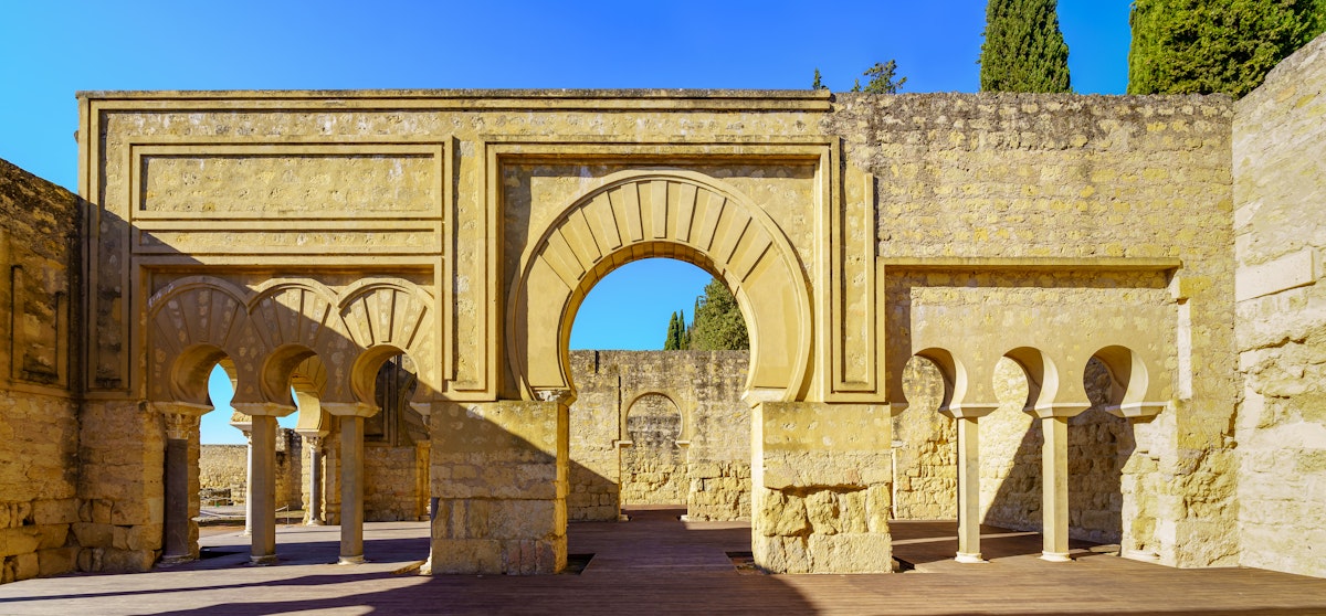 Ruins of medieval Arabic palace with columns and arched doors. Cordoba Medina Azahara.