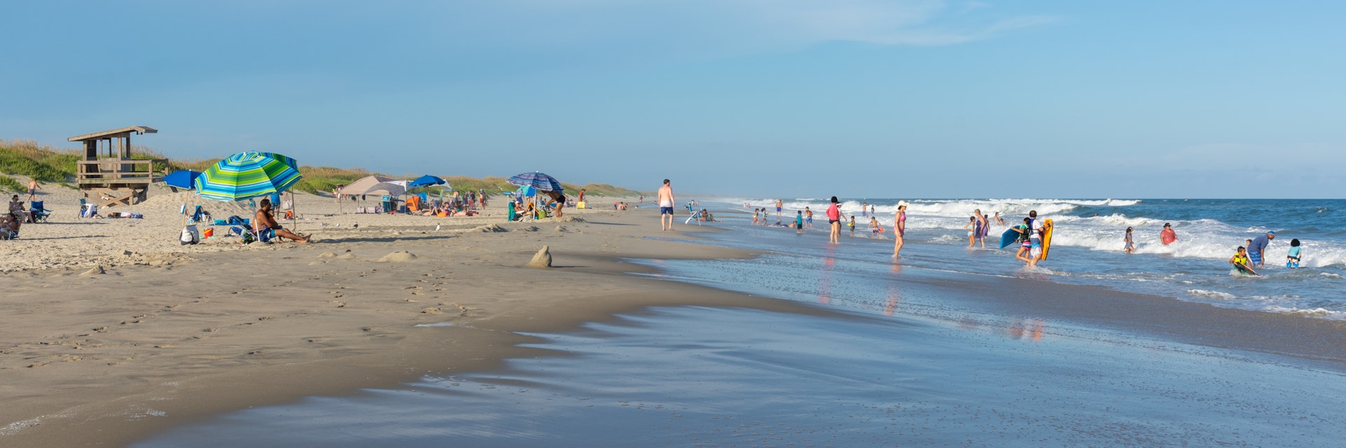 People relax on the beach and swim in the surf of the lifeguarded beach on Ocracoke Island.