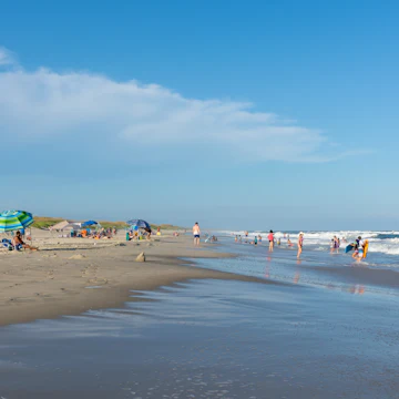 People relax on the beach and swim in the surf of the lifeguarded beach on Ocracoke Island.