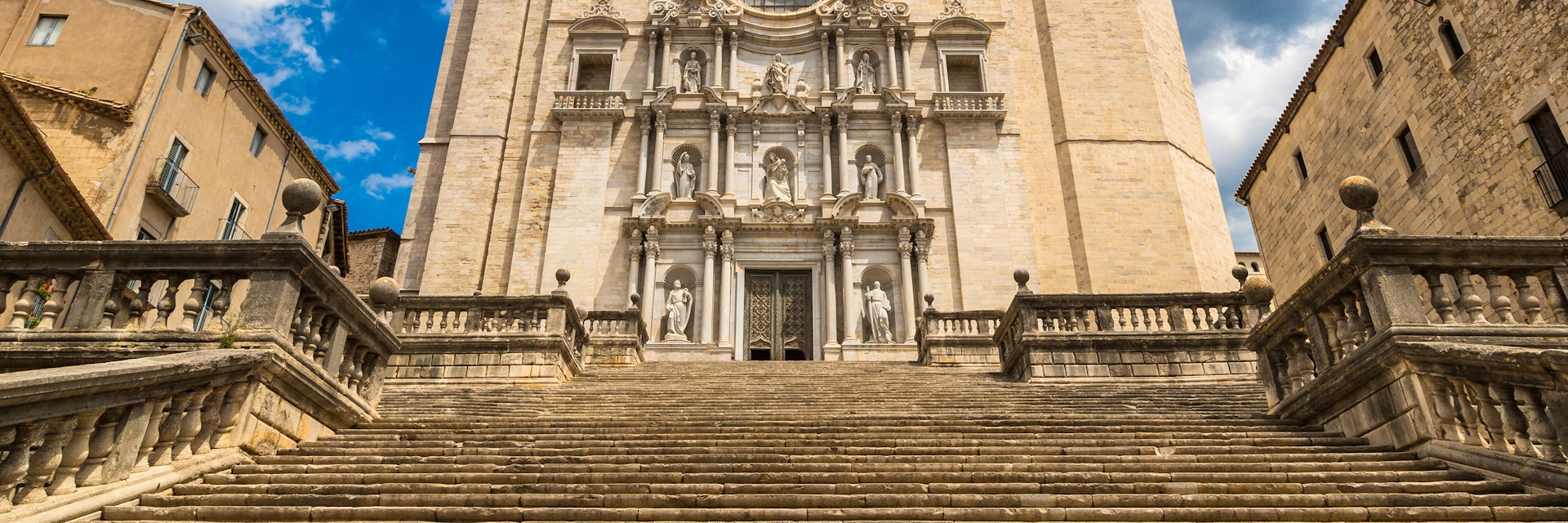 Girona cathedral facade with statues in a beautiful summer day, Catalonia, Spain.