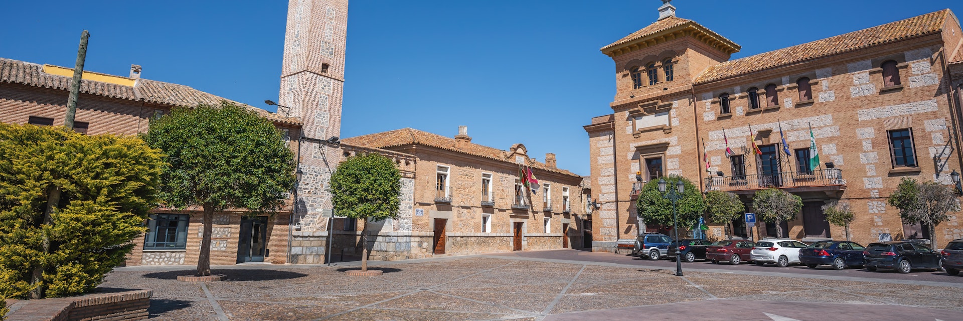 Plaza de Espana Square with Clock Tower (Torre del Reloj) and Consuegra City Hall - Consuegra, Castilla-La Mancha, Spain.