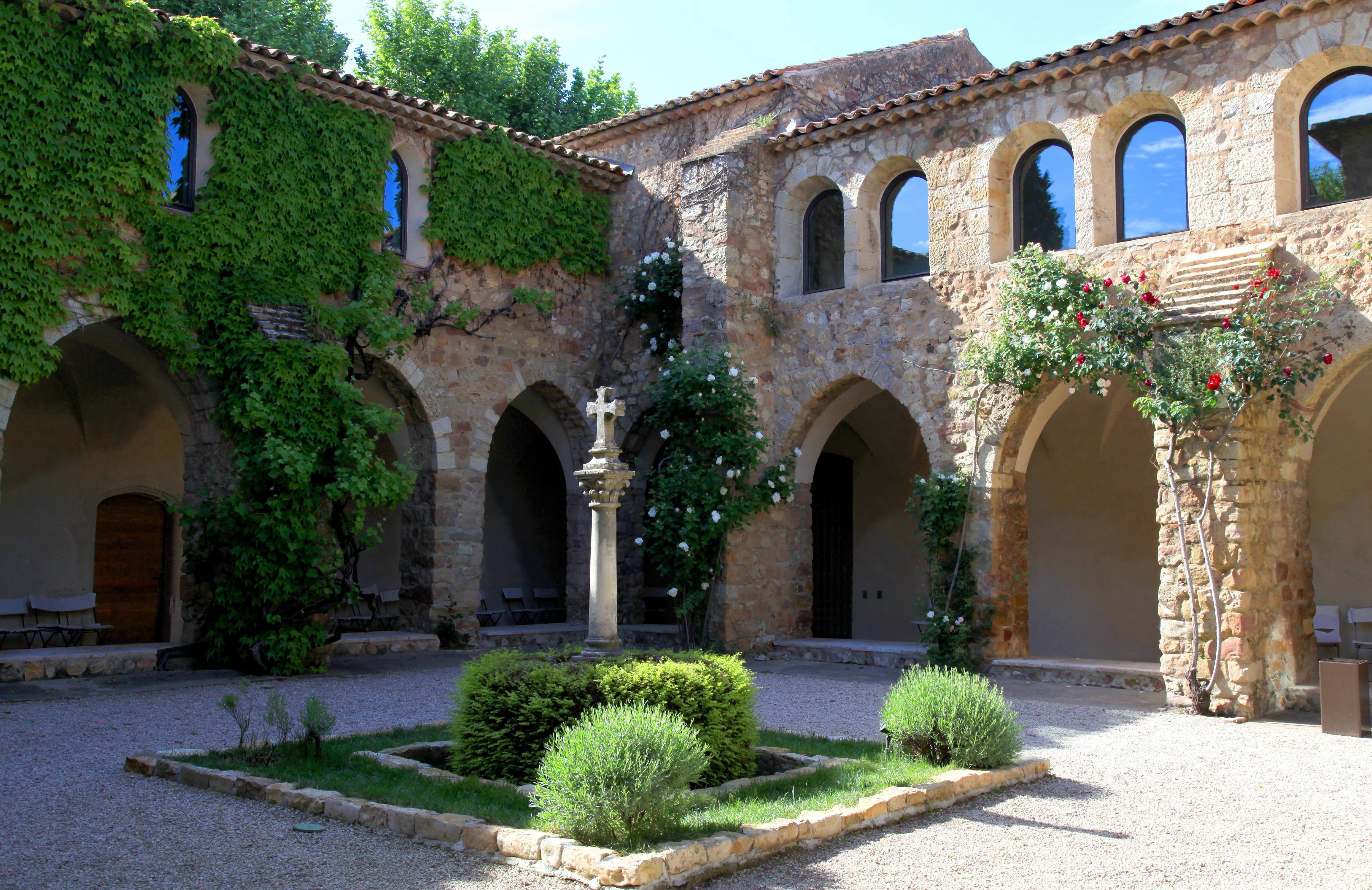 Medieval patio with roses in La Chapelle de Sainte-Roseline, Provence, France.