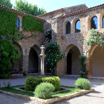 Medieval patio with roses in La Chapelle de Sainte-Roseline, Provence, France.
