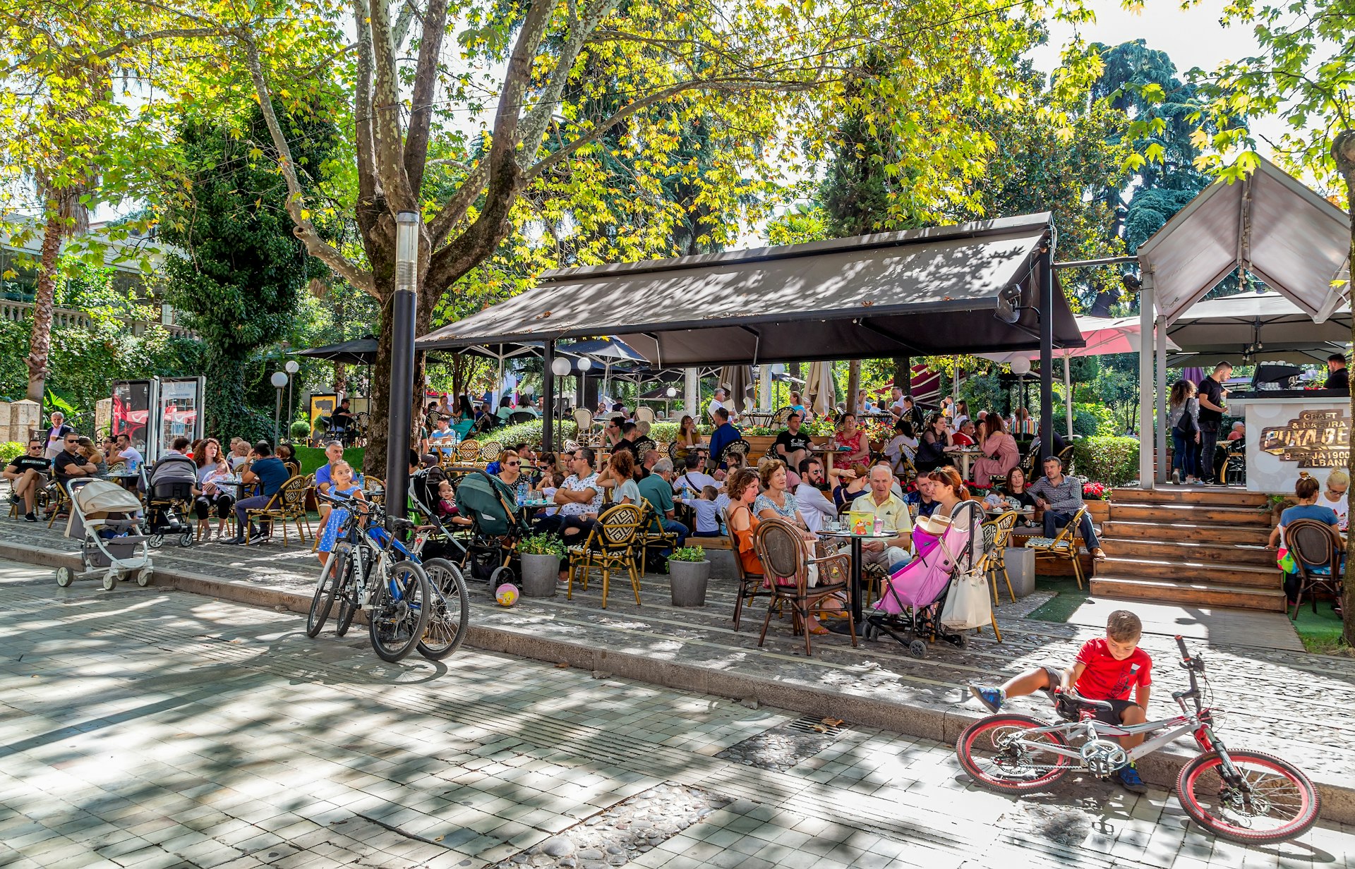 People rest at an outdoor cafe in Tirana