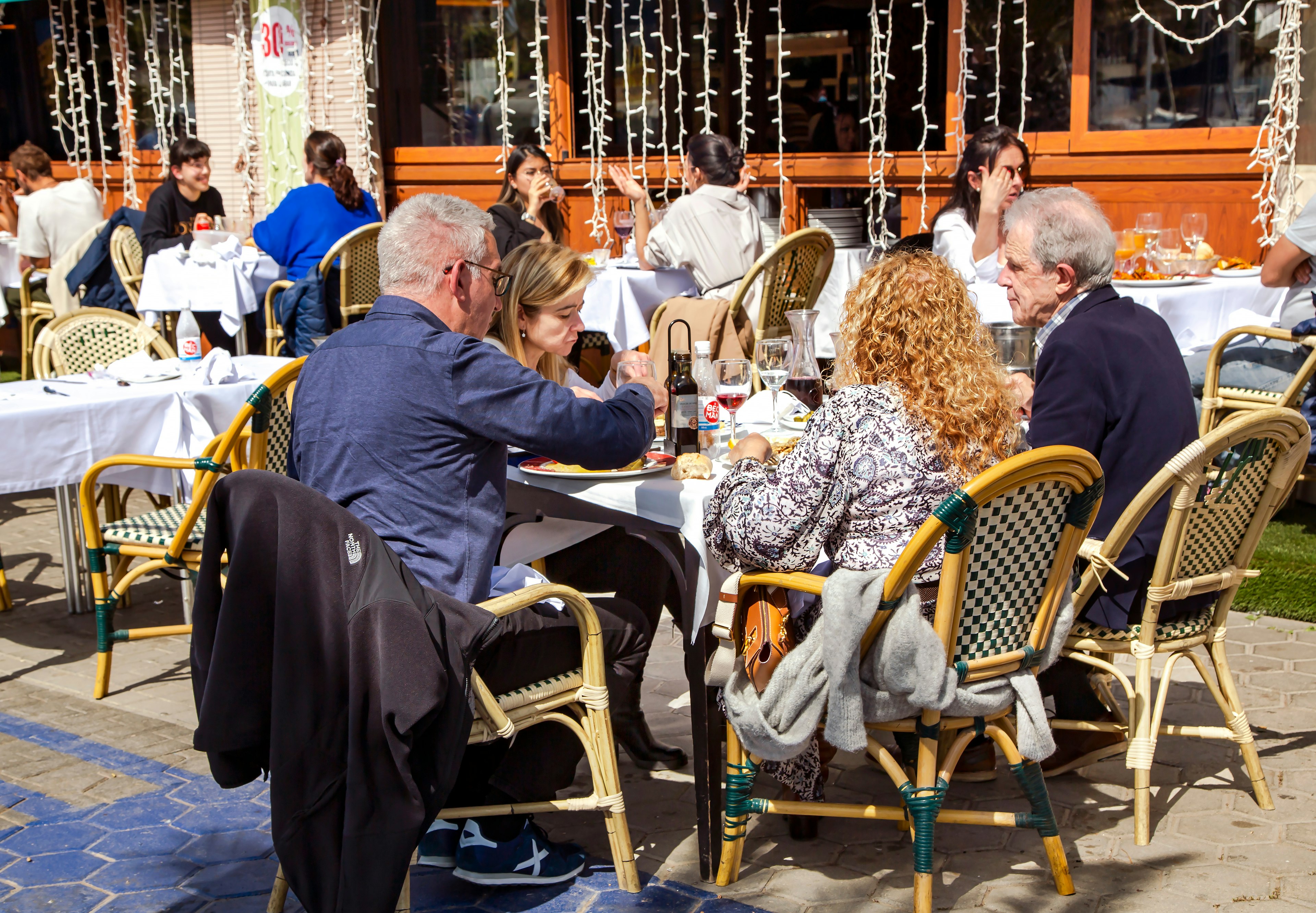 Family dine on the open veranda of restaurant La Barca del Salamanca on the Port Olympic