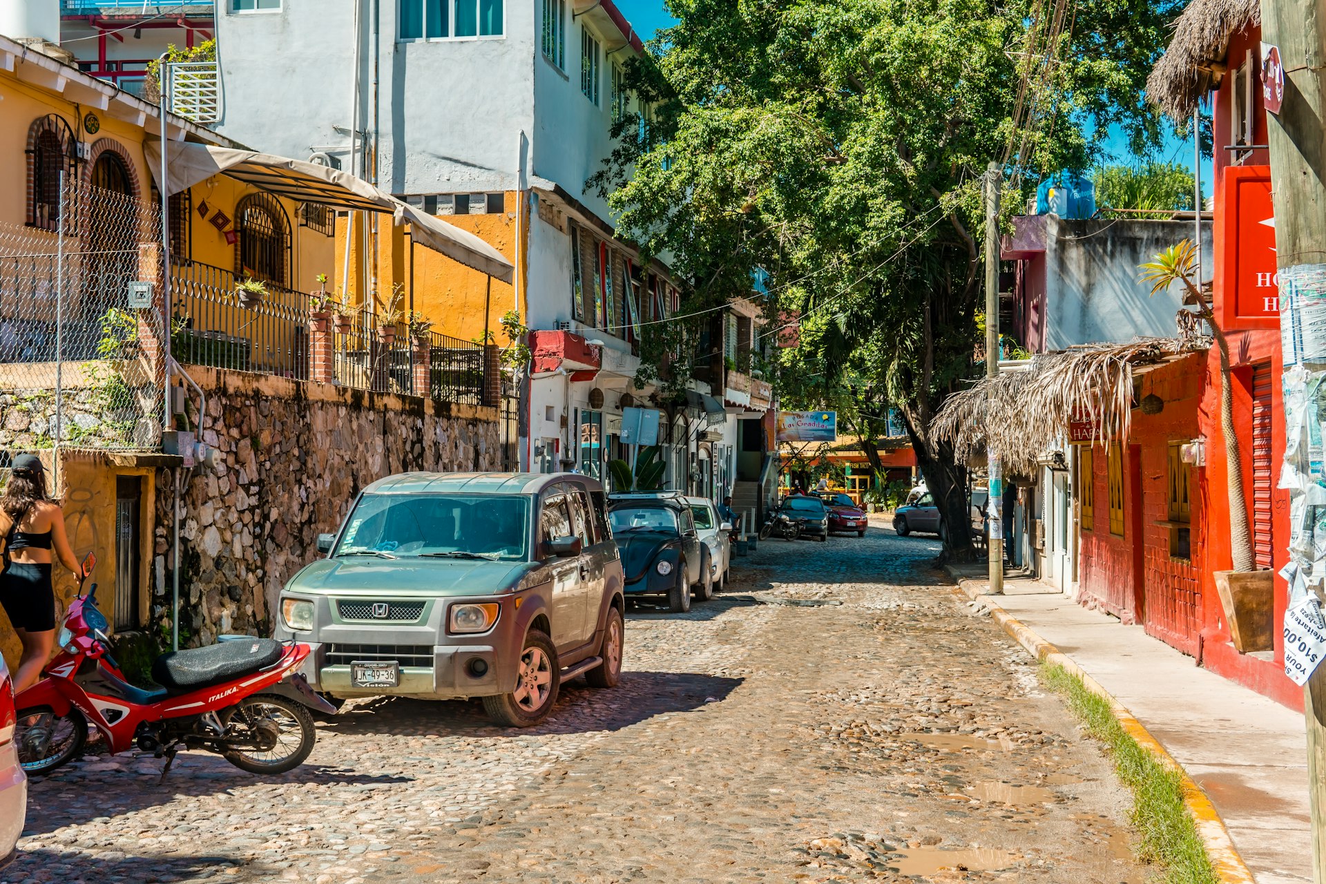 Street photography of cars and colorful buildings in Pueblo Magico, Sayulita