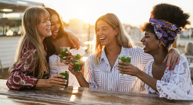 Happy girls having fun drinking cocktails at bar on the beach - Soft focus on center blond girl face; Shutterstock ID 2173391839; your: Jennifer Carey; gl: 65050; netsuite: Online Editorial; full: Things to do in Savannah 2173391839 Happy women having fun drinking cocktails at a bar on the beach