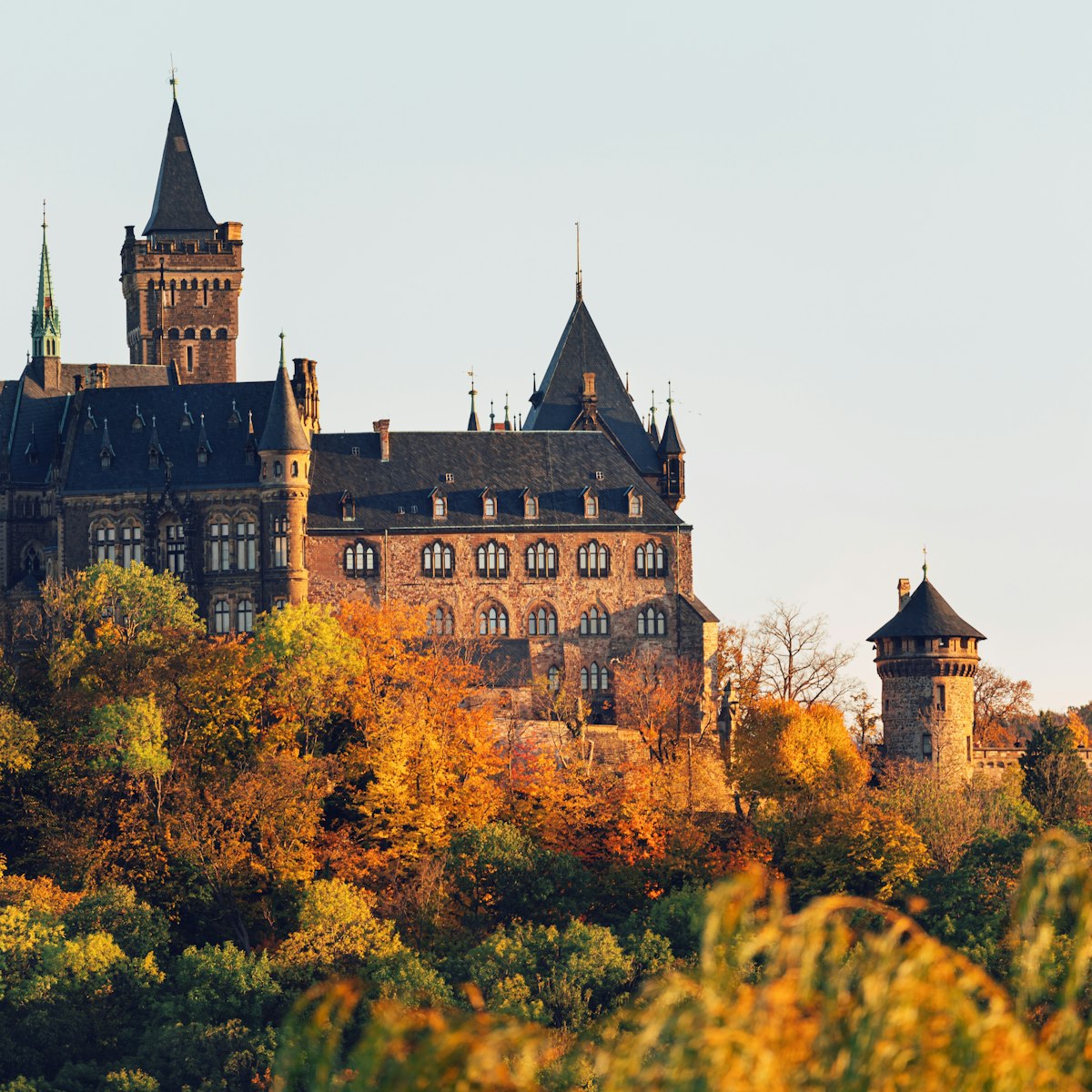 Historic Wernigerode Castle surrounded by an autumn landscape.