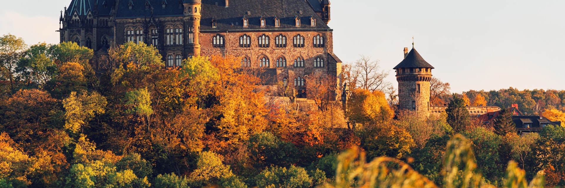 Historic Wernigerode Castle surrounded by an autumn landscape.