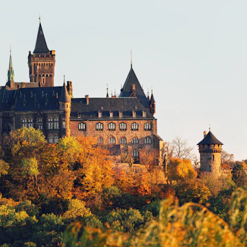 Historic Wernigerode Castle surrounded by an autumn landscape.