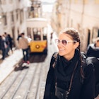 Young cheerful woman walking down the street of Lisbon.Amazed tourist visiting Europe off season during winter.Student in Portugal,Europe on a spring brake trip exploring big cities.Positive female; Shutterstock ID 797419789; your: Jennifer Carey; gl: 65050; netsuite: Online Editorial; full: Lisbon neighborhoods
797419789
Young cheerful woman walking up a hill in Lisbon with a tram parked behind her.