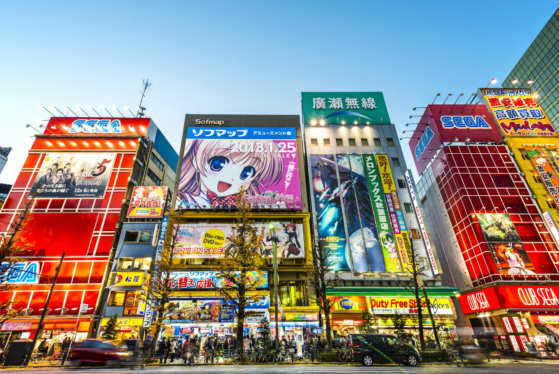 A run of shops with animae characters and video game stars blaze away in bright neon colours in Tokyo'sAkihabara district