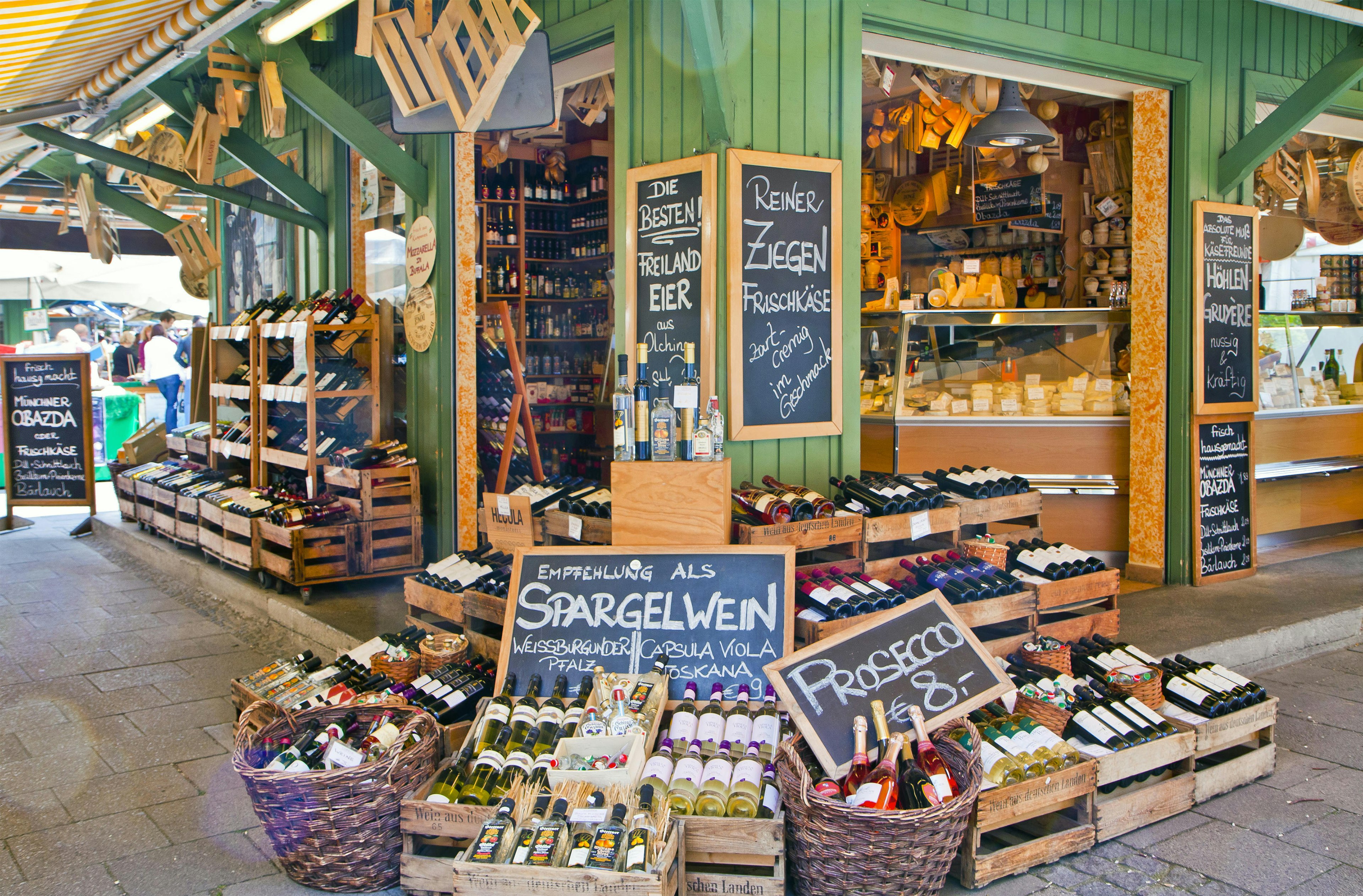 Alcohol and cheese on display at a stall in Viktualien open air market in Munich.