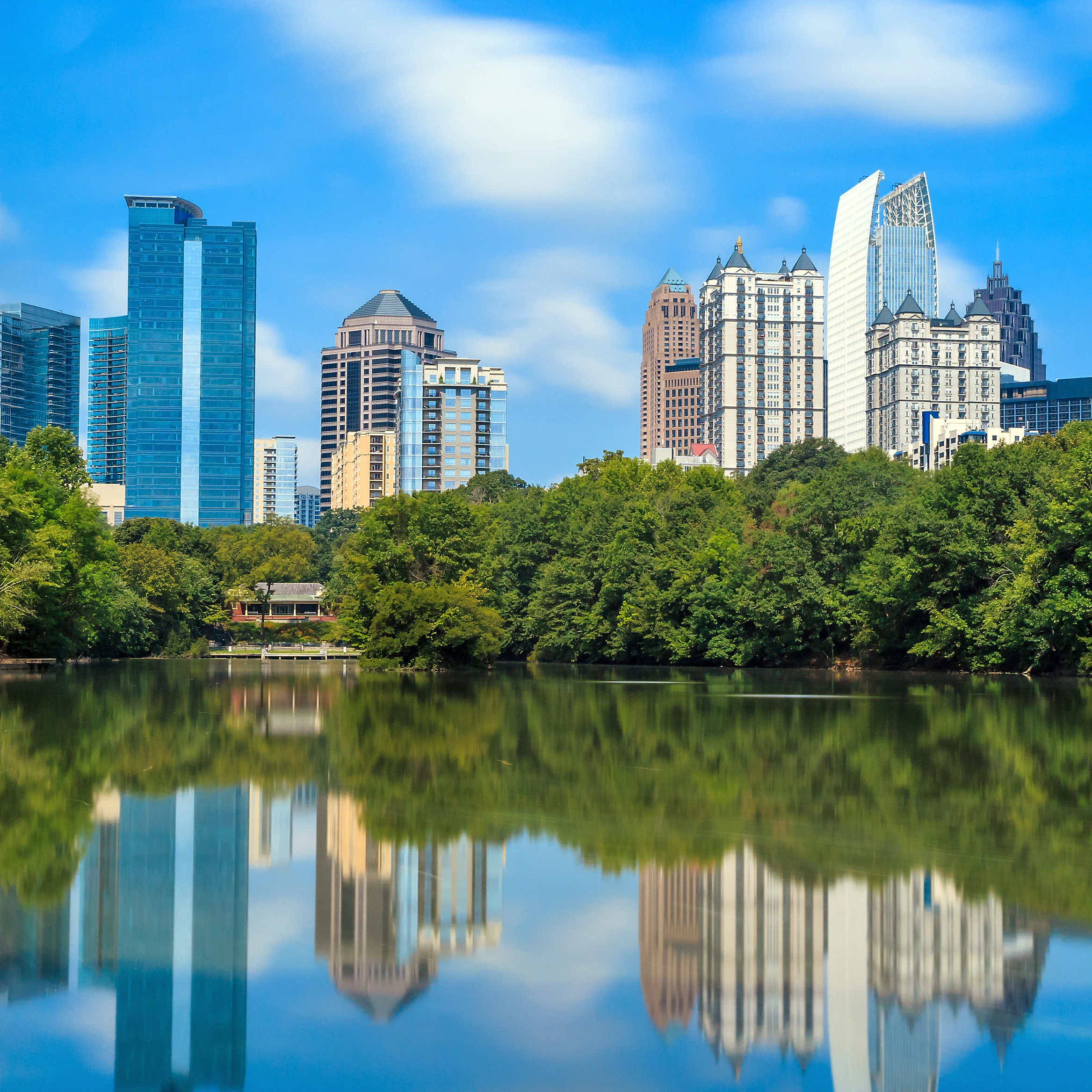 Skyline and reflections of midtown Atlanta, Georgia in Lake Meer from Piedmont Park.