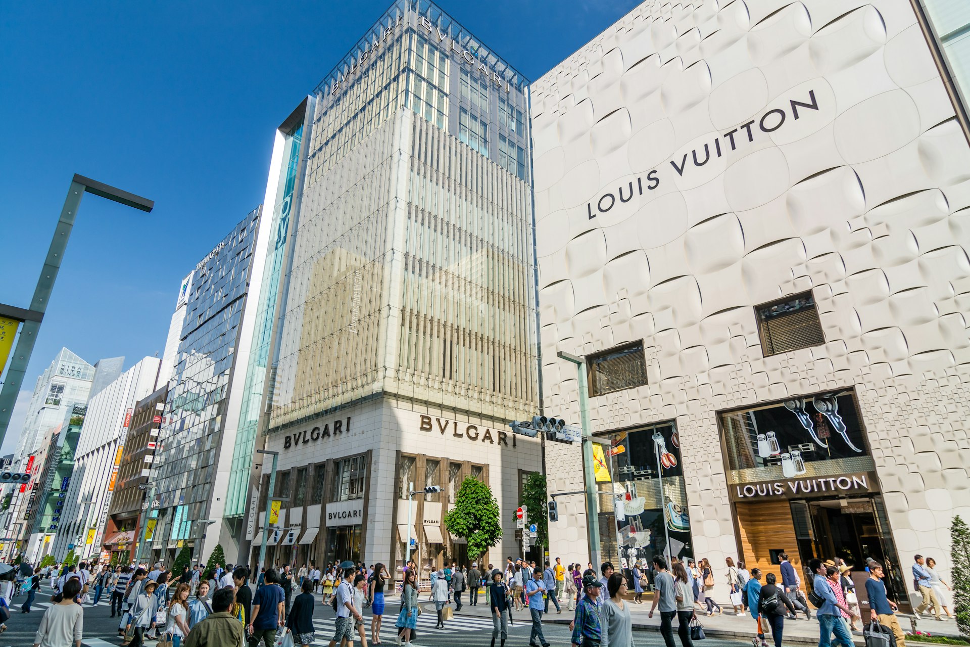 Crowds shopping in the luxury fashion centre in Ginza on weekend afternoons when the central Chuo Dori street is closed to traffic and becomes a large pedestrian zone.