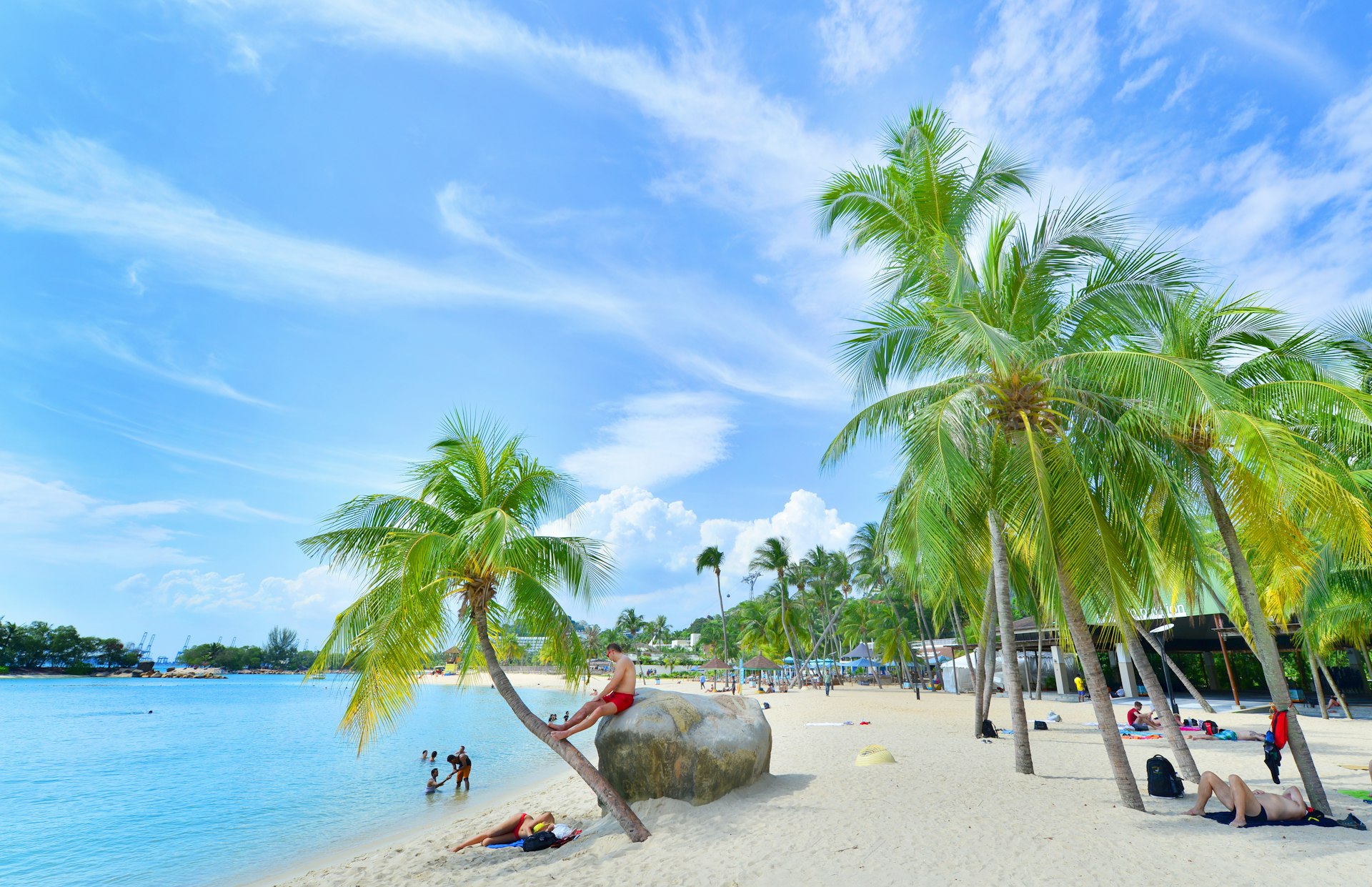 eople relax at Siloso Beach on the Island of Sentosa