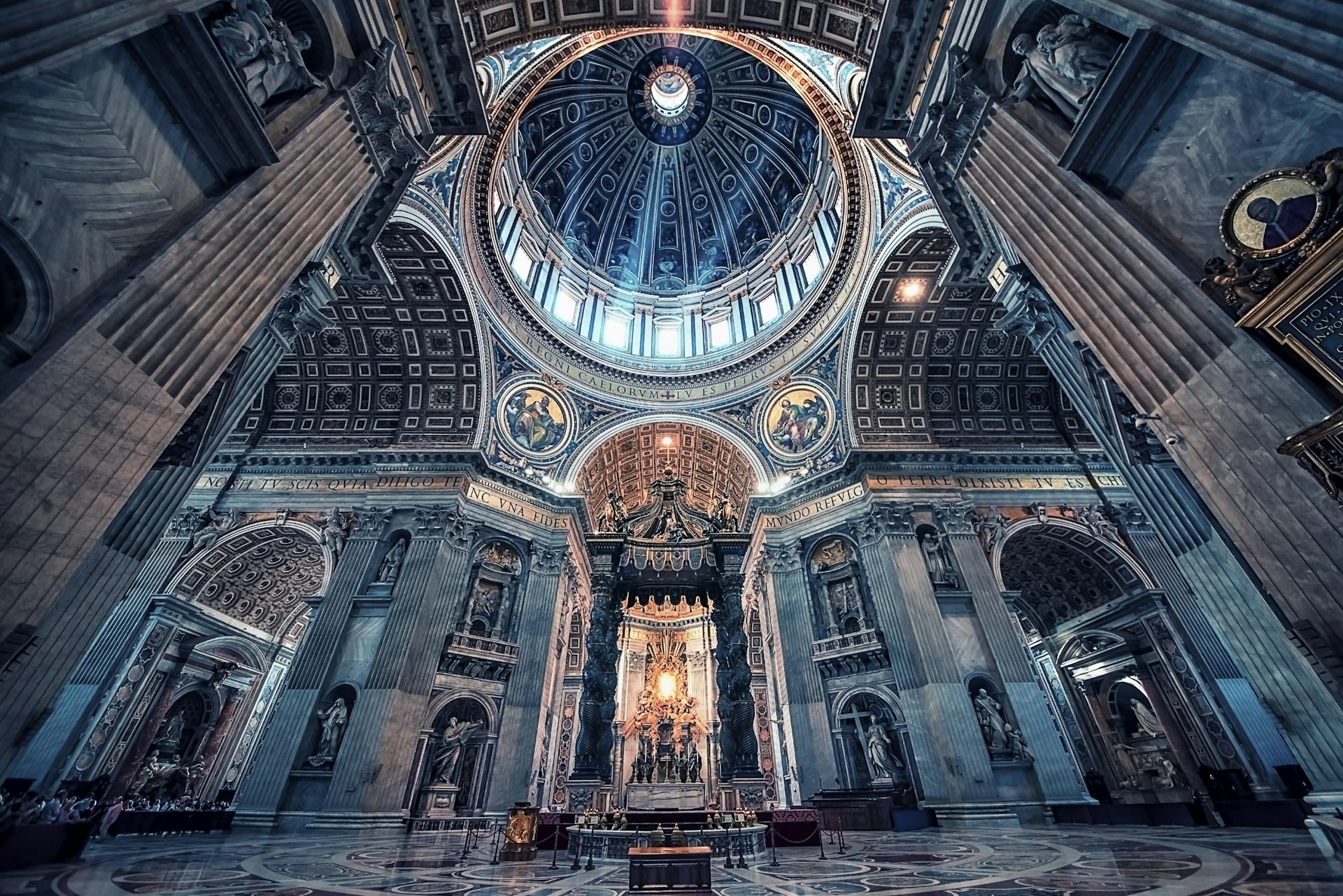 Inside an empty St Peter's Basilica in Rome looking up at the dome