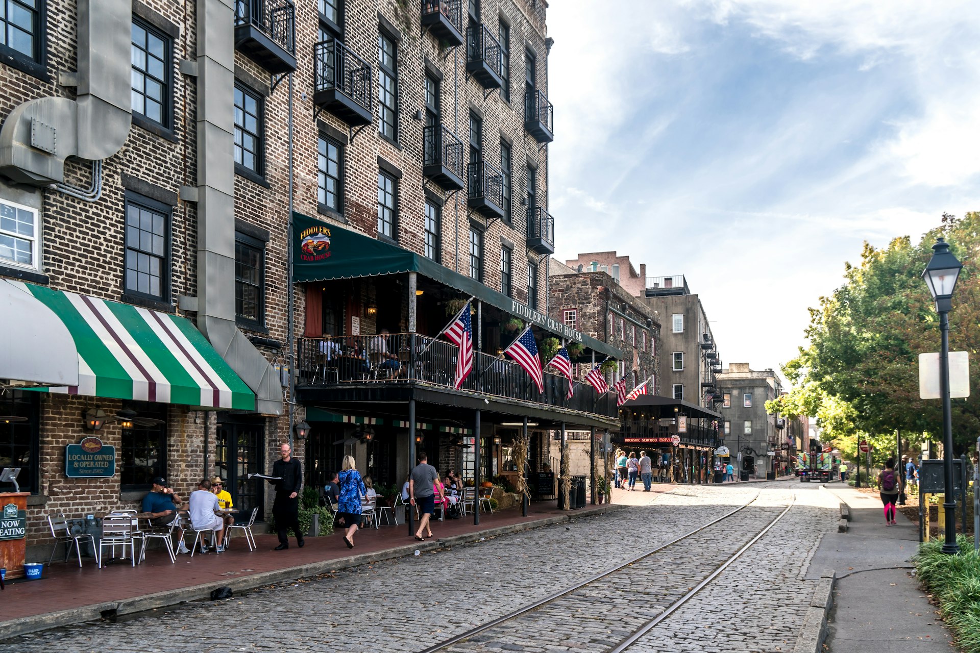 tourists explore the brick streets of Historical city Savannah in Georgia, USA