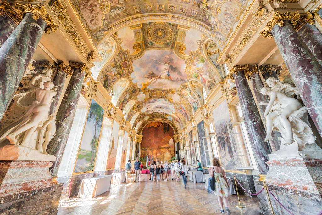 interior view of Toulouse's Place du Capitole, a large airy hallway with colorful frescoes on the ceiling