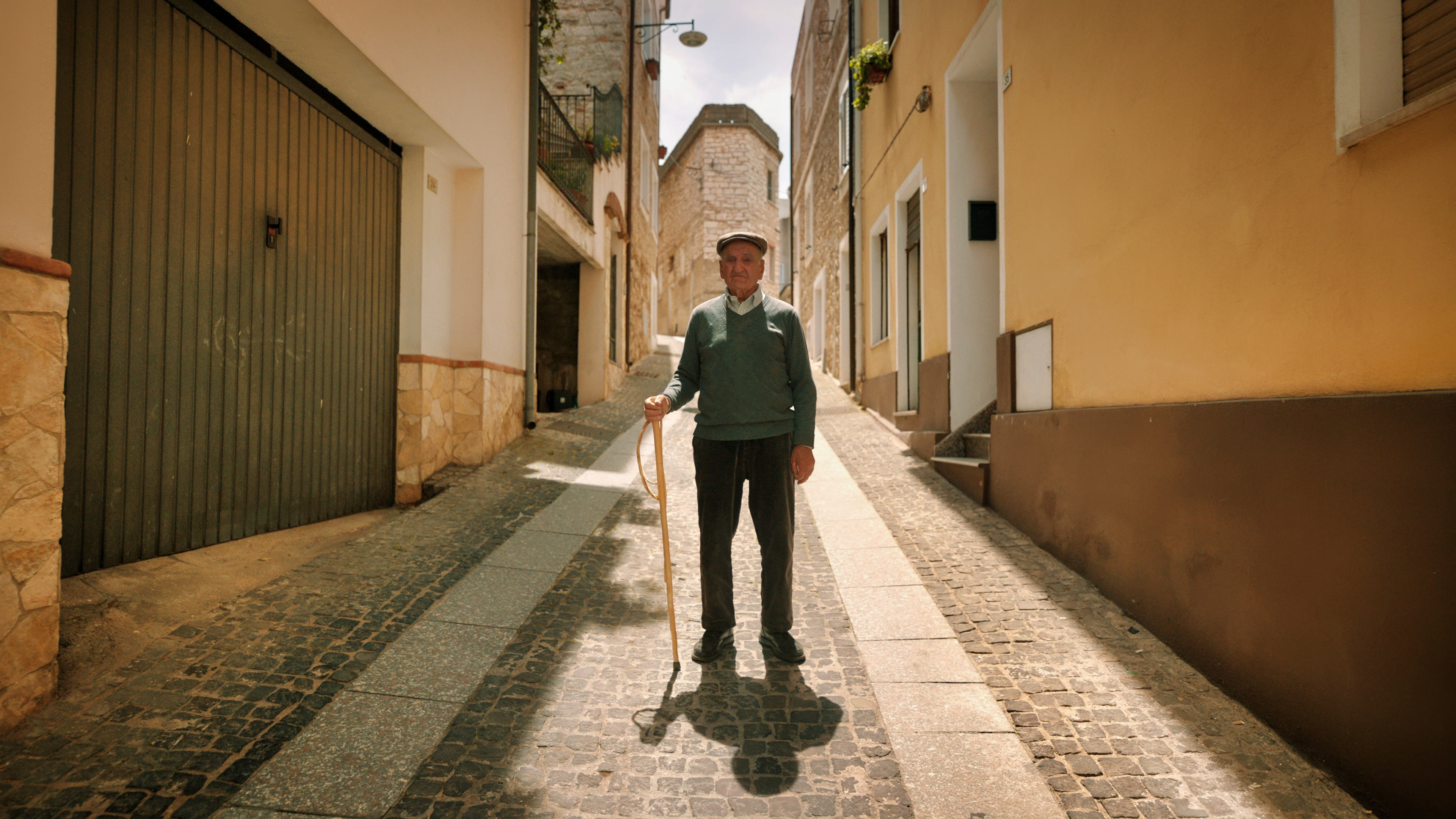 A superannuated man in a town street in Sardinia, Italy