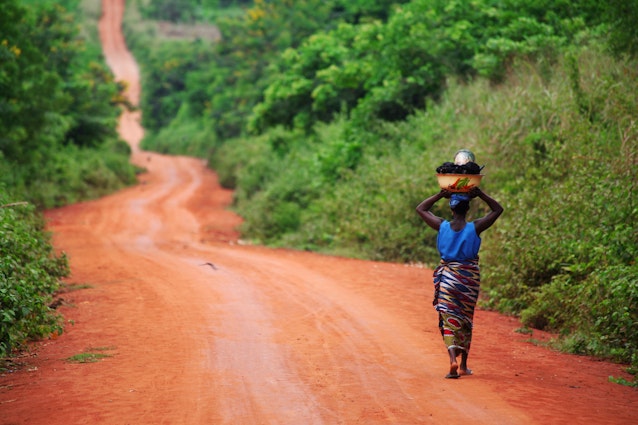 A woman walking on an unsurfaced road near Ouidah in Benin
