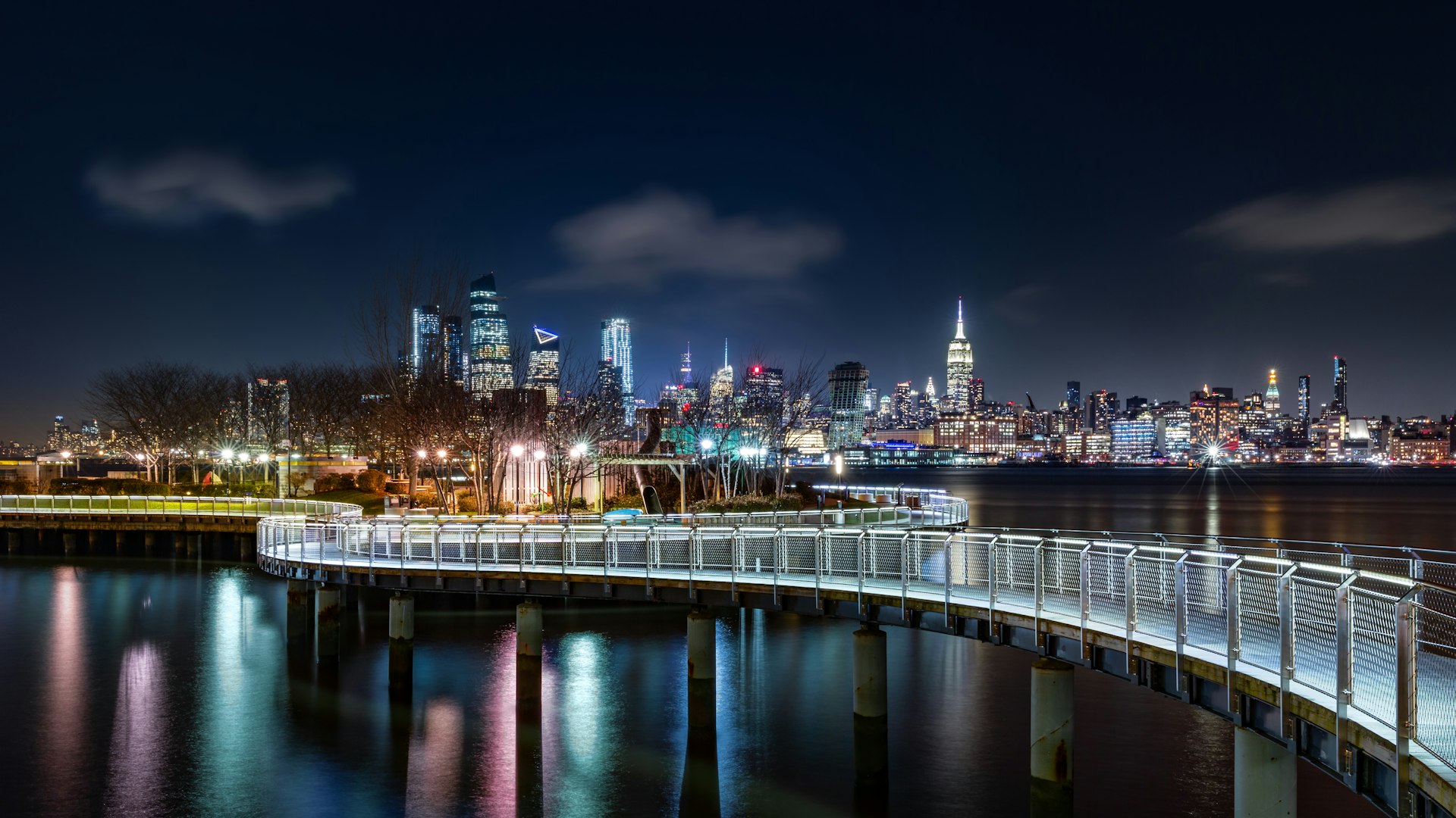 Pier C park in Hoboken, New Jersey by night, with the New York City skyline in the background