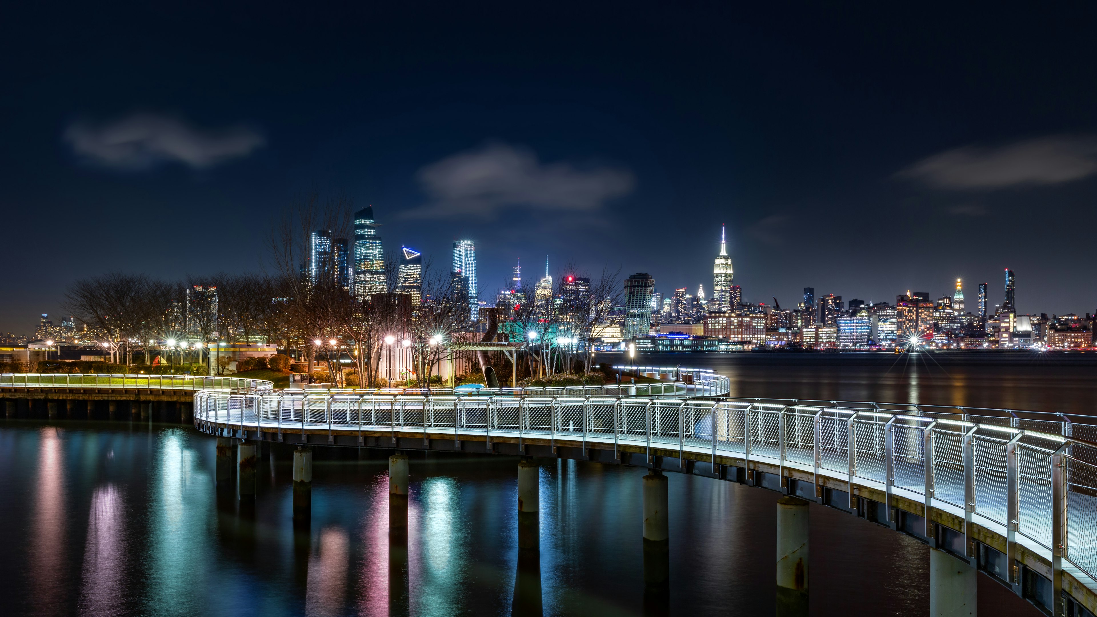 Pier C park in Hoboken, New Jersey by night, with the New York City skyline in the background