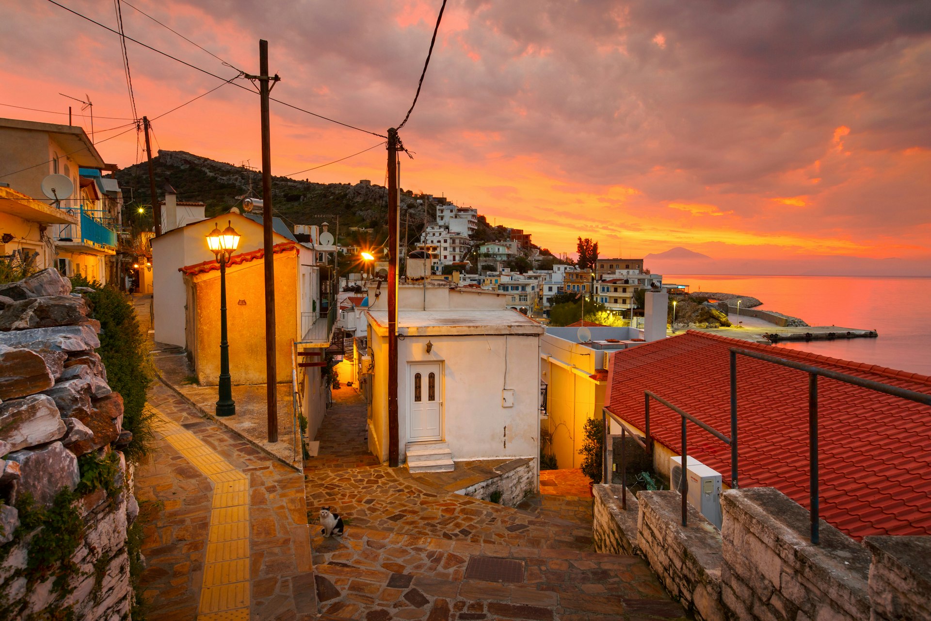 The quiet streets of Agios Kirikos village on Ikaria island in Greece at sunset