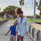 Beautiful young mother and her young son smiling happily together on a wooden pier with a sunflare behind them. Single mother and her adorable kid. Family togetherness
1148319494