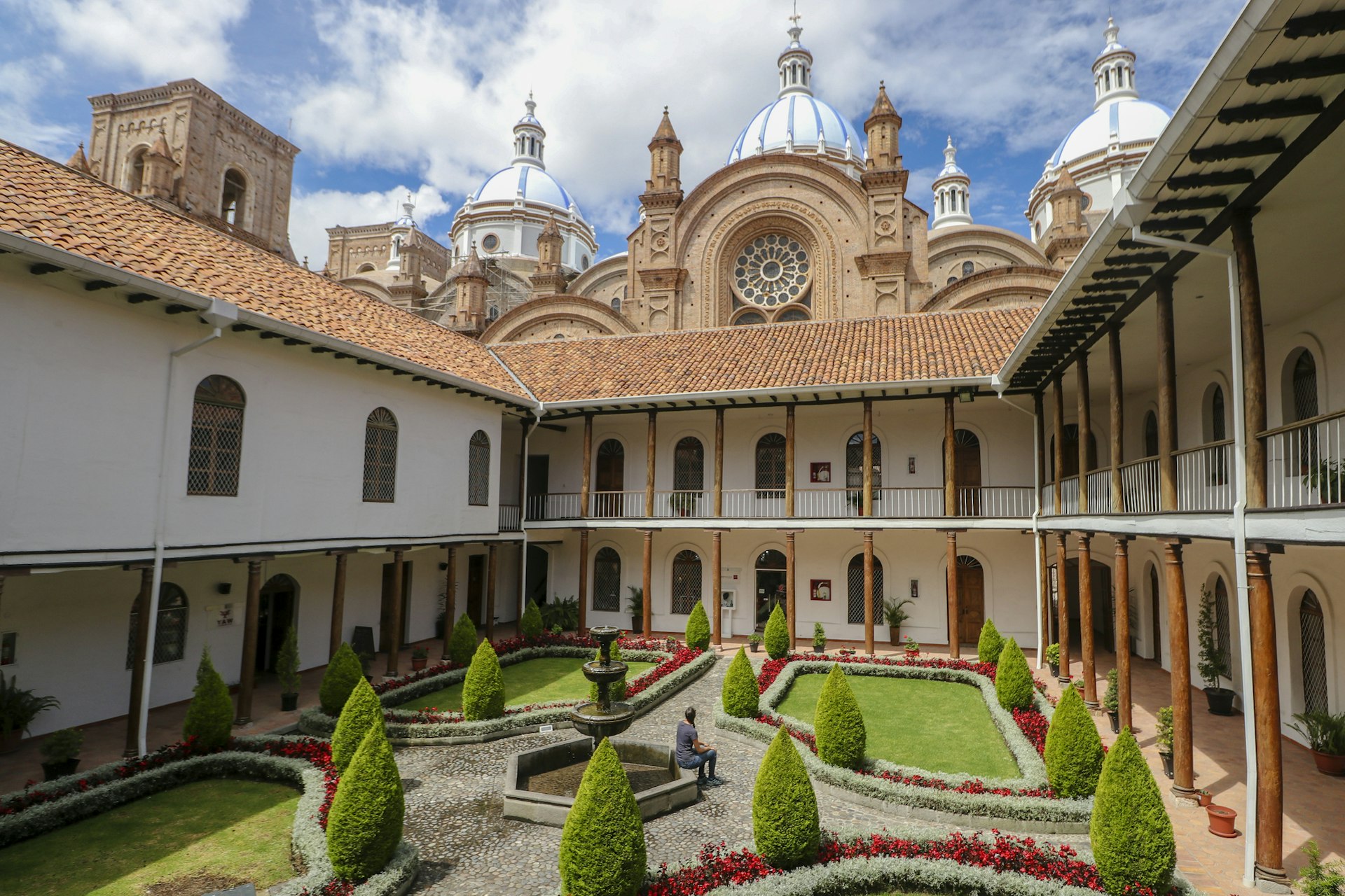 A woman sitting in the Cathedral of the Immaculate Conception in Cuenca, Ecuador