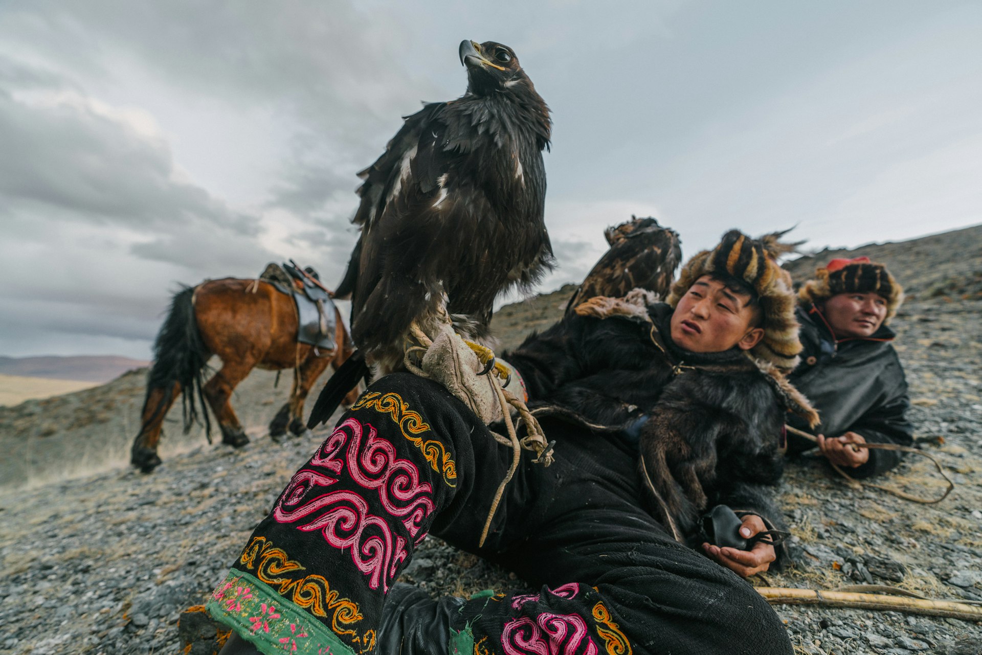Eagle hunters resting on a mountainside in Mongolia