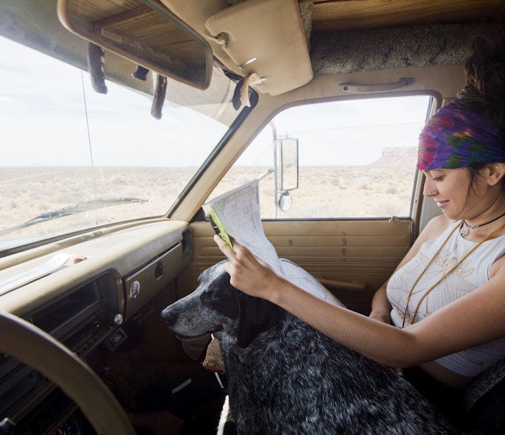 1274434048
directions, expressing positivity, presence
A young woman looking at a map in her car in Monument Valley, Arizona