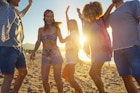People dancing on the beach in Ibiza, Spain