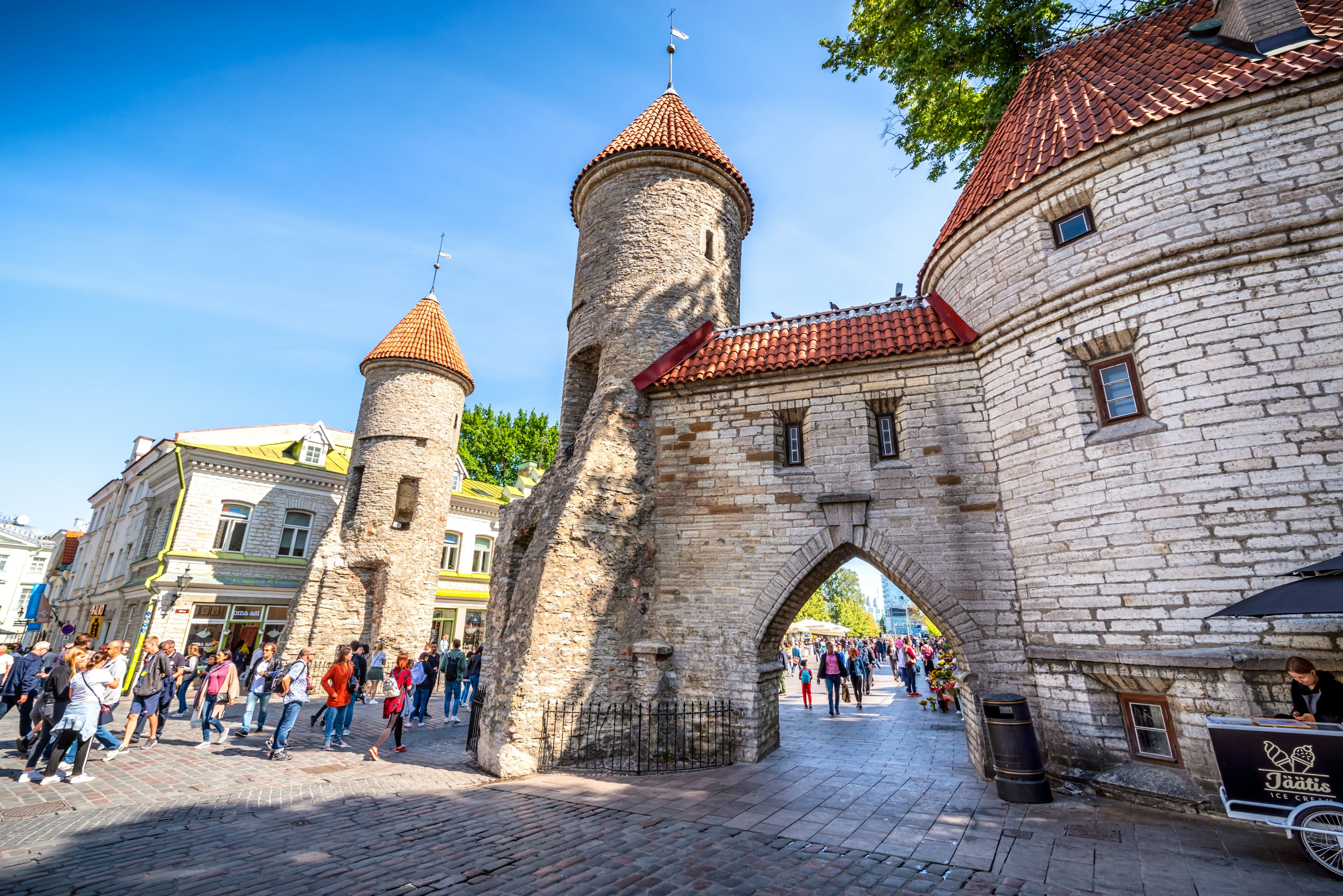 Old Town city walls with tourists milling around the city gate