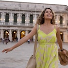 Happy woman traveling through Italy and smiling in Venice