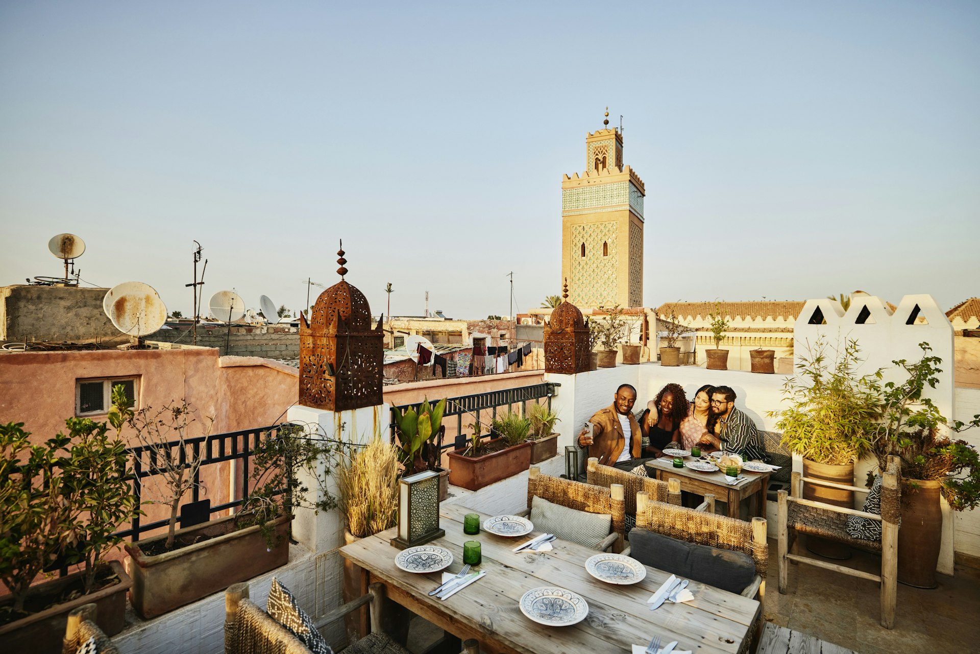 Diners in the sunshine at a rooftop restaurant in Marrakesh, Morocco