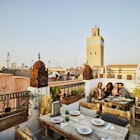 Wide shot of couple taking selfie at rooftop restaurant in Marrakech - stock photo 	© Thomas Barwick / Getty Images