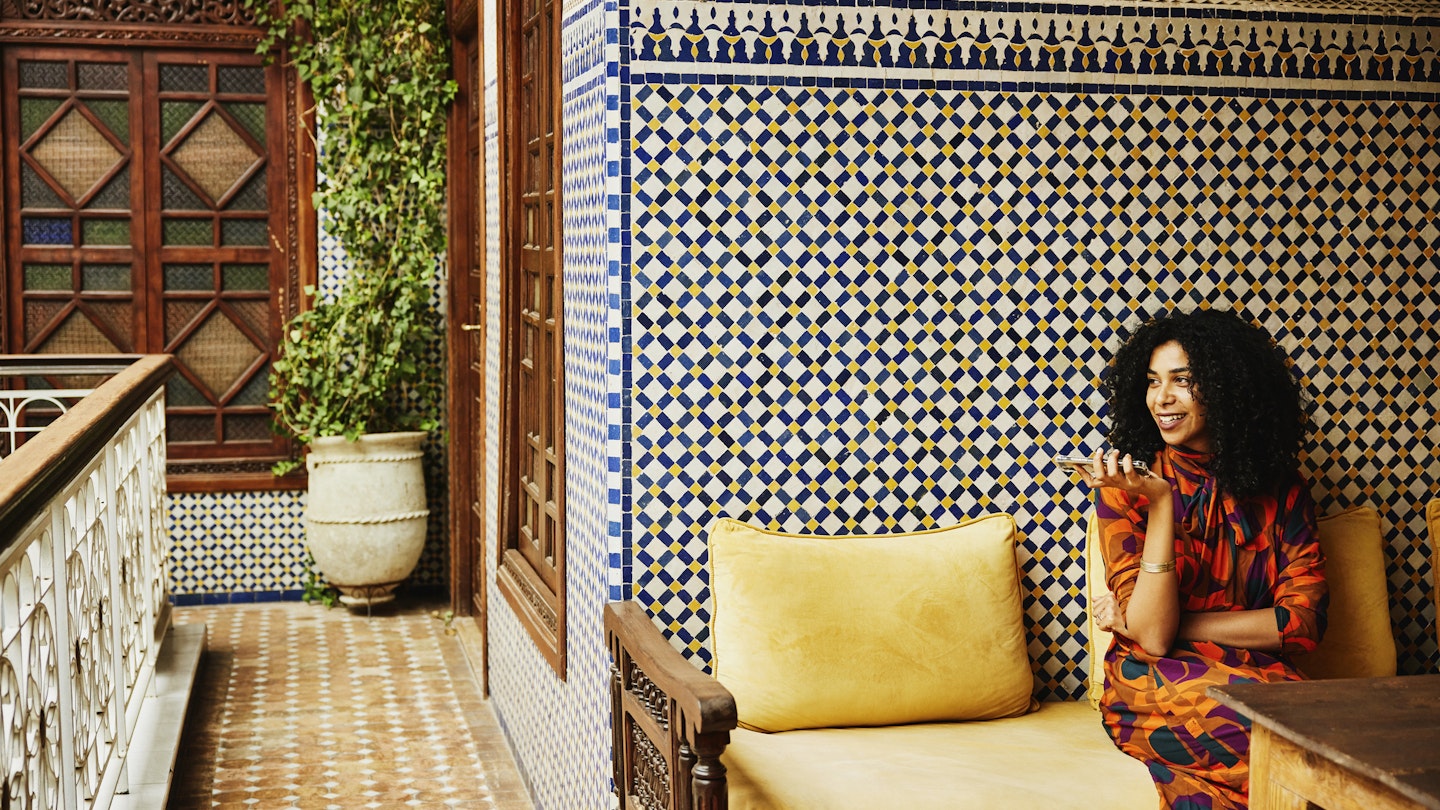 Wide shot of smiling woman relaxing in alcove of ornately decorated riad while on vacation in Marrakech
1466437874
exotic travel, riad
Wide shot of smiling woman relaxing in an alcove of an ornately decorated riad while on vacation in Marrakech © Thomas Barwick / Getty Images