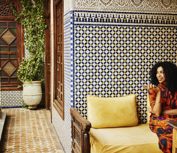 Wide shot of smiling woman relaxing in alcove of ornately decorated riad while on vacation in Marrakech
1466437874
exotic travel, riad
Wide shot of smiling woman relaxing in an alcove of an ornately decorated riad while on vacation in Marrakech © Thomas Barwick / Getty Images