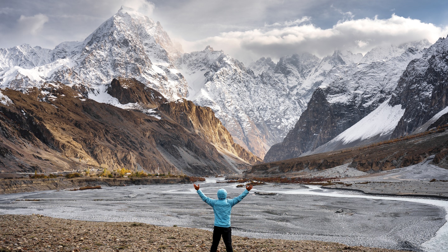 A trekker looks at the peaks of the Karakoram Range, Pakistan