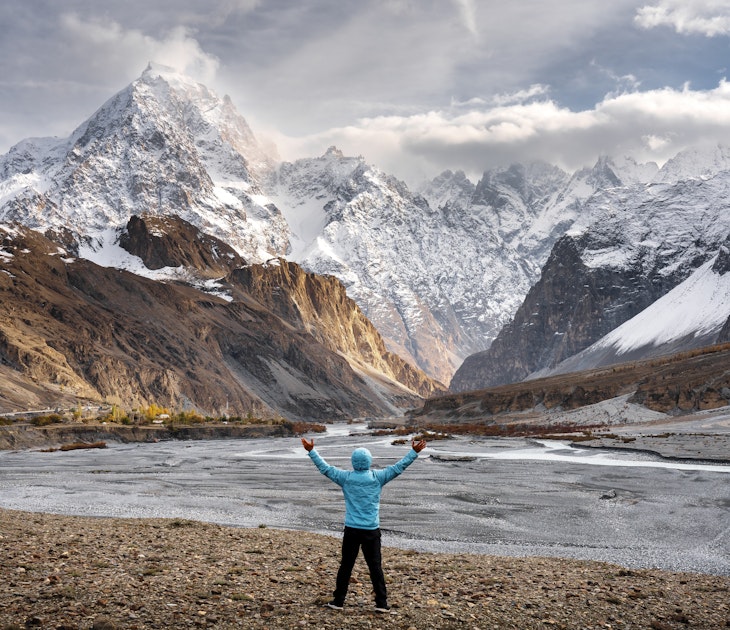 A trekker looks at the peaks of the Karakoram Range, Pakistan